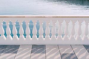 Elegant White Railing with Serene Water Background photo