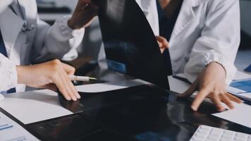 Two doctors are working on a computer and a piece of paper video
