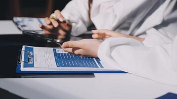 A person in a lab coat is using a clipboard video