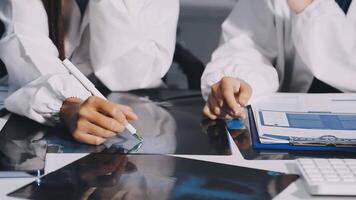 Two doctors working on a computer and paper video