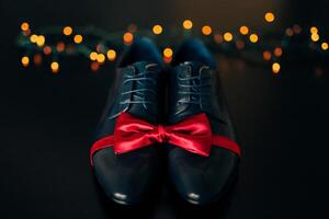 Elegant and Stylish Shoes with a Red Ribbon on Dark Surface photo