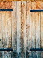 Beautiful Rustic Wooden Double Doors Enhanced with Iron Hinges photo