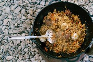 Savor the flavor of a Delicious Outdoor Stew cooked in a Cast Iron Pot photo