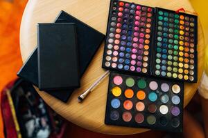 Vibrant and Colorful Makeup Palettes with Brushes Arranged on a Table photo