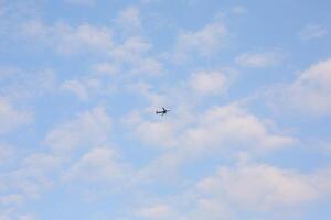 Enjoy the view of aircraft soaring in a blue sky with clouds photo