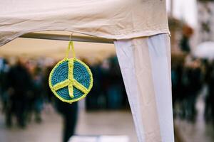 A vibrant and colorful peace symbol is hanging at the event photo