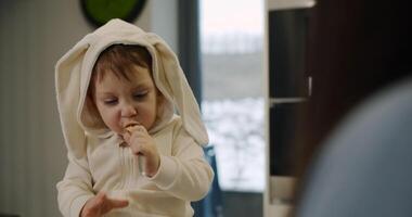 A of a baby and a boy in bunny costumes showcases joy video