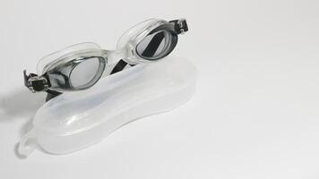 Black swimming goggles isolated on white background. photo