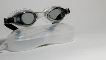 Black swimming glasses isolated on white background photo