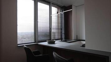 A cozy kitchen with natural light, a sink, table, and chairs for gatherings video
