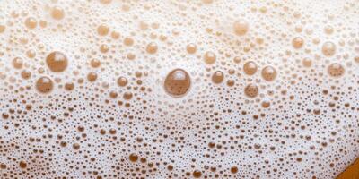 Close-up of frothy foam bubbles on coffee beverage surface photo