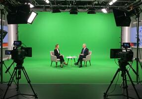 Filming Talk Show Interview with Green Screen and Professional Cameras photo