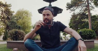 A bearded man practices mindfulness in a tranquil park, radiating calm video