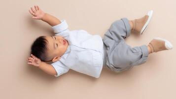 A toddler lying on the floor with raised arms and emotional expression, symbolizing toddler meltdown, sensory overload, and challenges of early childhood parenting. photo