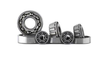 Several ball and roller bearings showcased on a white surface, ready for applications. photo