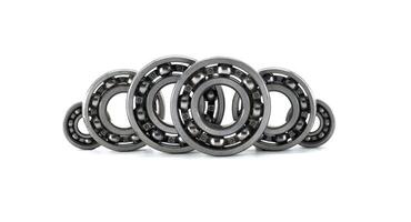 Several ball bearings neatly arranged in front of a white background, ready for use. photo