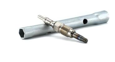 Diesel Engine Glow Plug with Socket Tool on White Background photo