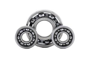 Three metallic ball bearings forming a triangular shape isolated on white background photo