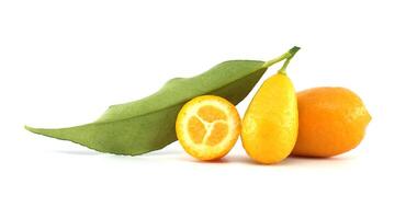 Fresh kumquats with leaf and a half kumquat showing the pulp photo