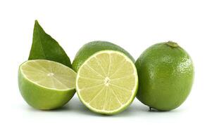 Fresh limes showing pulp, leaf and whole fruit on white background photo