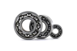 Various sized ball bearings neatly arranged against a plain white backdrop, showcasing engineering design. photo