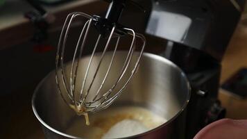 Adding spoon of flour to mixer bowl for baking dough video