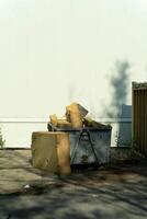 Garbage Bin Overflowing with Yellow Foam on Asphalt Surface photo