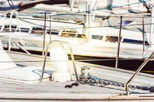 Yachts moored at marina with focus on deck details, nautical concept, sunny background photo