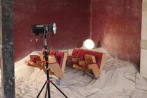 A beautifully designed artistic indoor setup featuring sand, striking lighting, and ambiance photo