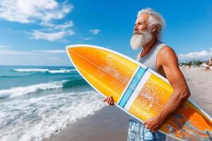 An old man with a beard and a surfboard on the beach photo