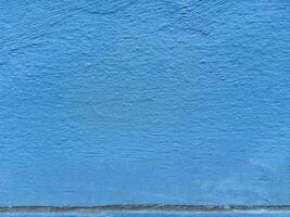 Textured blue wall surface with subtle color variations and minimalist design photo