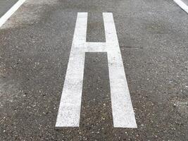 Helicopter landing pad marking on urban concrete surface photo