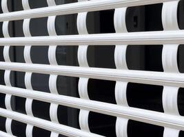 White metal grid pattern on a building window for security and design photo
