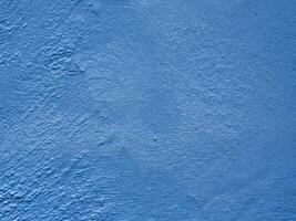 Textured blue wall surface with rough pattern background photo