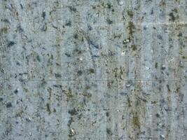 Close-up of textured gray cement wall surface with weathered patterns photo