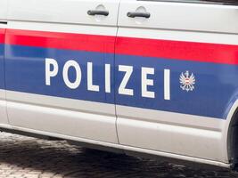 Austrian police vehicle side view displaying polizei and national emblem photo