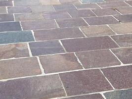 Close-up of varied color stone brick pavement with irregular patterns photo