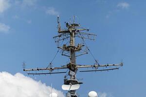 The mast of a large yacht with navigation equipment bottom view photo