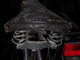 saddle of old vintage ancient bicycle detail close up photo