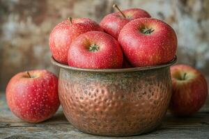 Rustic display antique copper bucket brimming with crisp apples photo