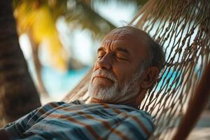 An older man is sleeping in a hammock photo
