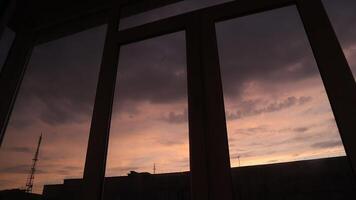 Sunset in the city, view from the window, timelapse video