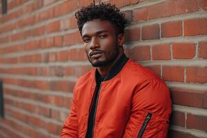 Urban Cool Stylish Man Strikes a Pose Against Brick Wall photo