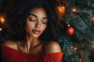 A beautiful woman in a red sweater is surrounded by christmas decorations photo