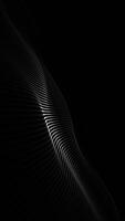 Stylish black minimalist tech background with a digital fractal wave gently rippling towards the camera. This elegant vertical technology background with copy space is full HD and a seamless loop. video