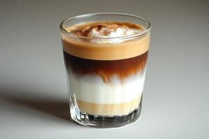 An espresso drink with a white and brown topping photo