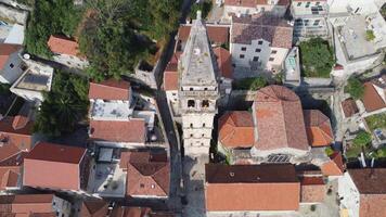 Top down view of the bell tower of the city of Perast in the Bay of Kotor, Montenegro. Building with the background of the town and the Adriatic Sea video