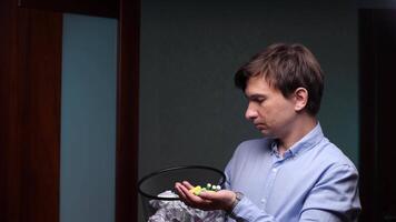 Office worker holding batteries and looking at trash can for recycling video