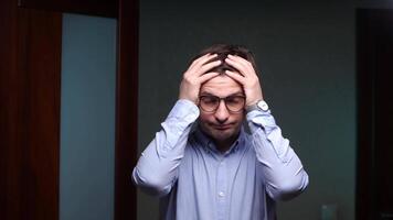 Stressed businessman holding head in hands. frustration at work video