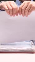 vertical Office worker tearing paper document, contract in half at desk with binders video
